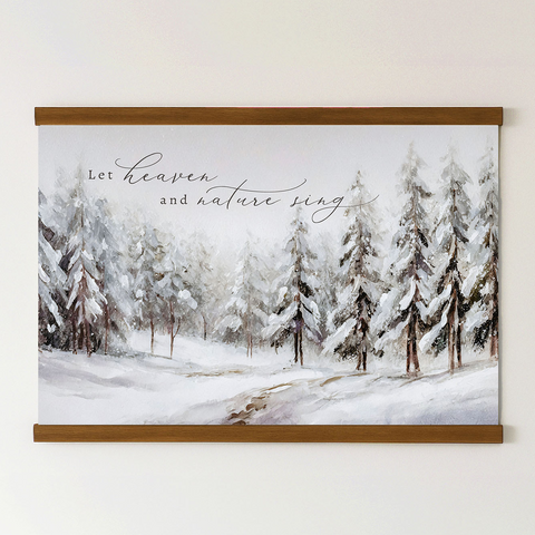 A framed painting depicting a snowy forest with pine trees covered in snow, accompanied by the text 