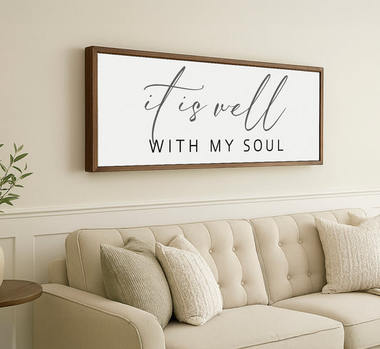 a living room with a couch and a framed sign on the wall