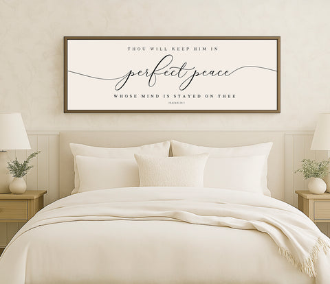 a bed with a white comforter and pillows