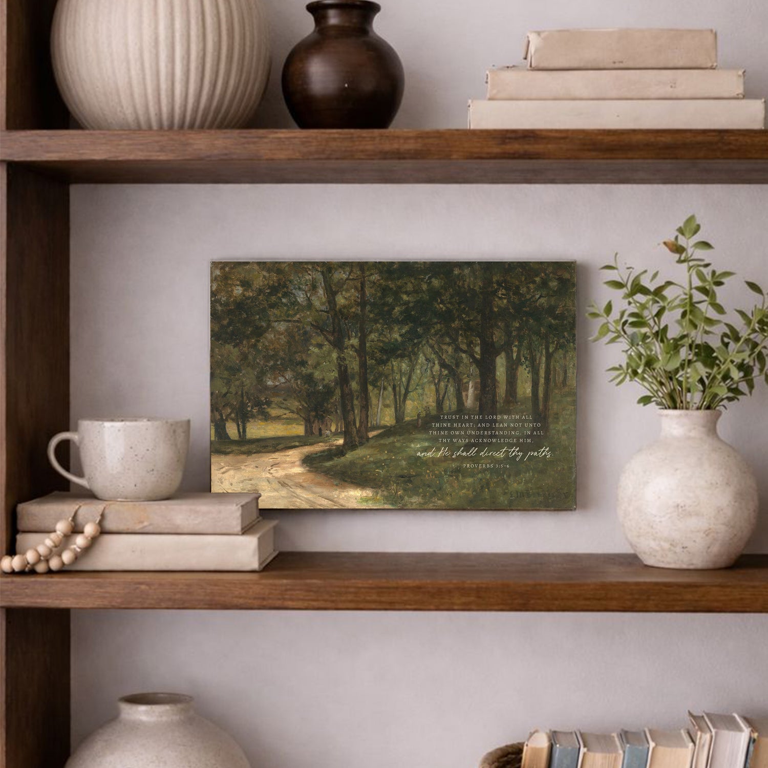 a wooden bookshelf with various decorative items and a framed landscape painting hanging on the wall.