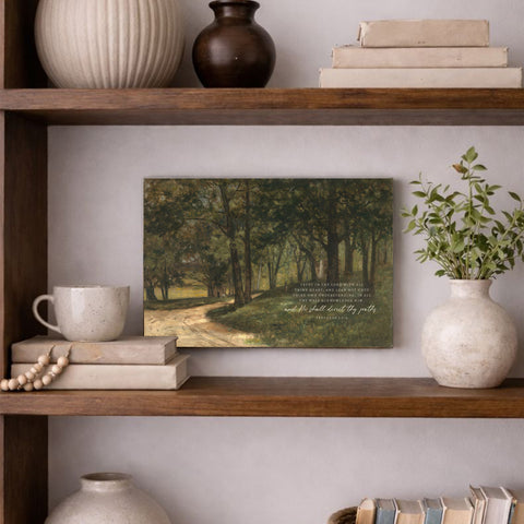 a wooden bookshelf with various decorative items and a framed landscape painting hanging on the wall.