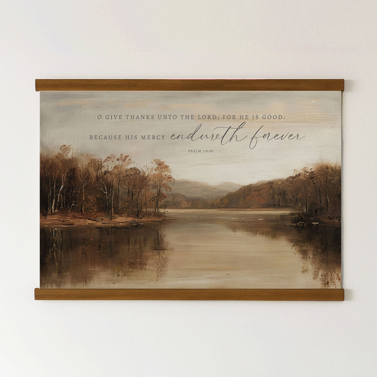 The image is a framed print of a serene landscape featuring a lake surrounded by trees and mountains. The text on the print reads, "O give thanks unto the Lord, for he is good. Because his Mercy endures forever. Psalm 18:1-3".
