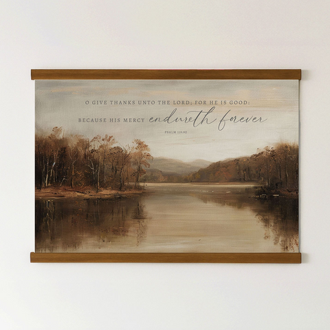 The image is a framed print of a serene landscape featuring a lake surrounded by trees and mountains. The text on the print reads, 