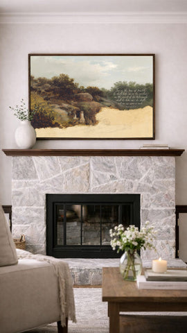a cozy living room with a stone fireplace, a framed landscape painting above it, and a wooden coffee table with a vase of flowers in the foreground.