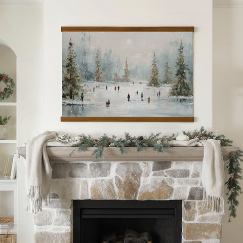 a cozy fireplace adorned with a wreath and a painting of people ice skating on a frozen lake.