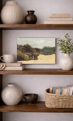 a wooden bookshelf with various decorative items and books arranged on the shelves. The bookshelf has three shelves, and the items include a painting, a vase, a coffee cup, a bowl, and a basket. The painting is a landscape scene, and the bookshelf is set against a light-colored wall.