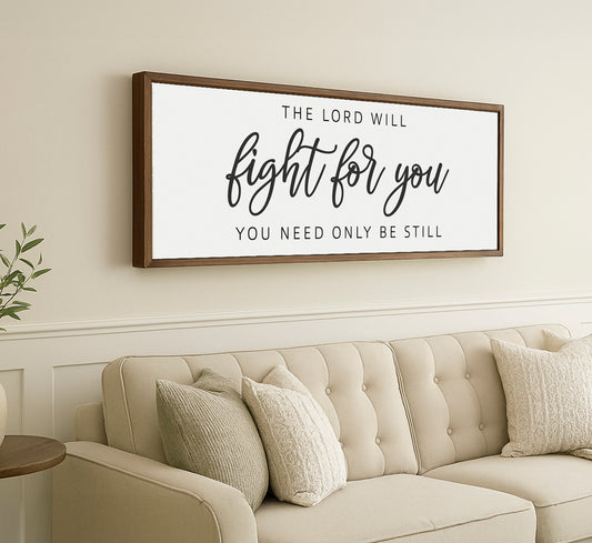 a living room with a couch and a framed sign on the wall