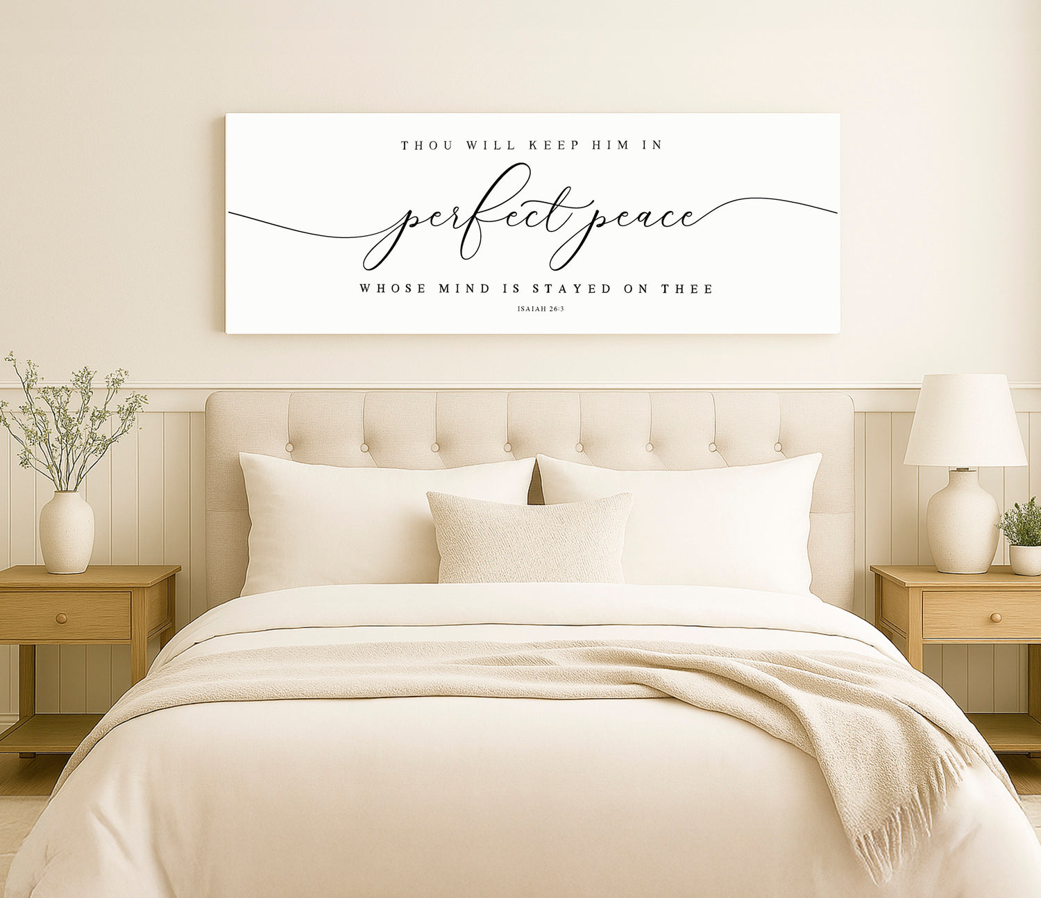 a bed with a white comforter and pillows
