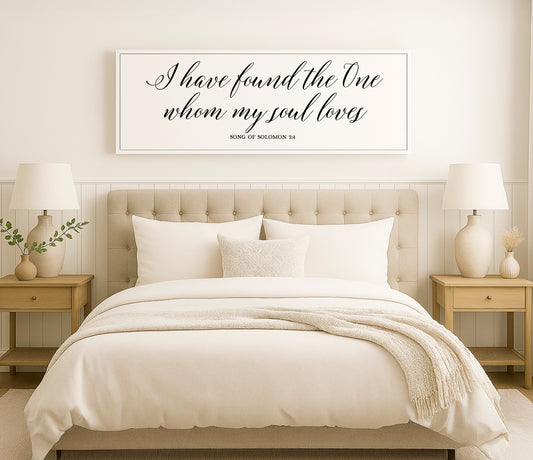 a bed with a white comforter and pillows