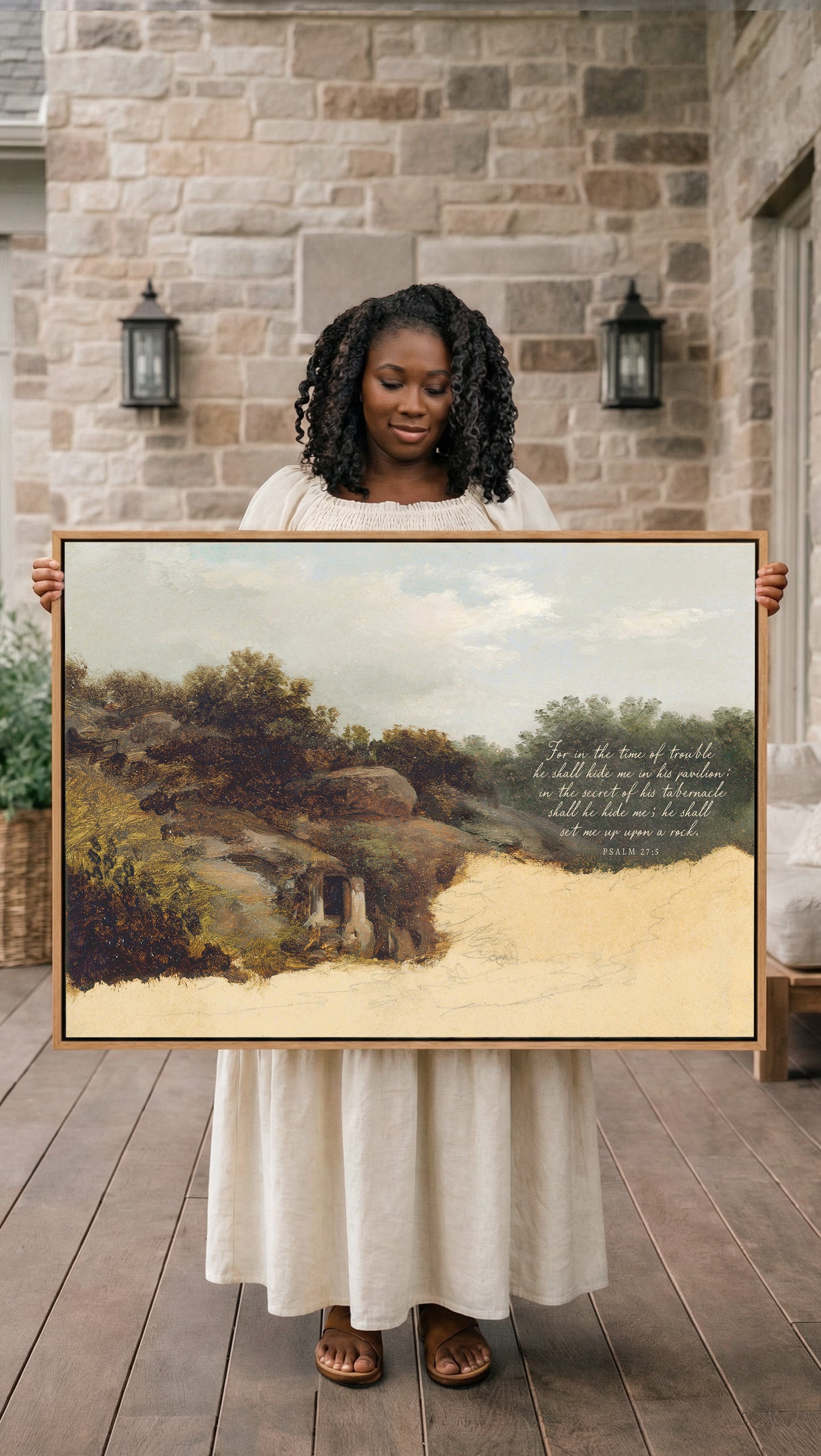 A woman in a white dress holds a large painting of a landscape, standing in front of a stone wall with lanterns.
