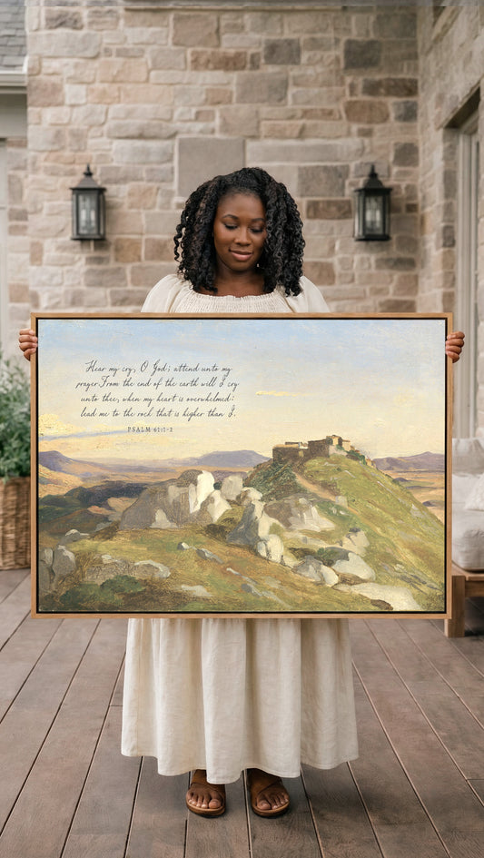 A woman in a white dress holds a large framed painting of a mountainous landscape, with a Bible verse visible in the image.