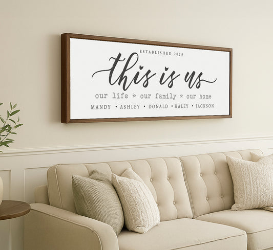 a living room with a couch and a framed sign on the wall
