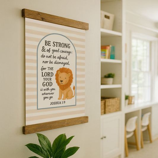 a wall hanging with a lion and a Bible verse, along with a plant in the foreground.