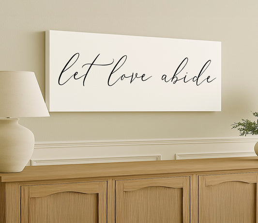 a white sign that says let love abidie