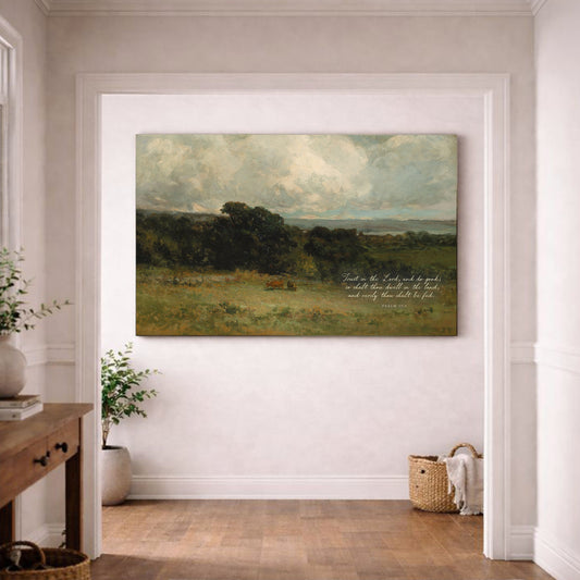 a large landscape painting hanging on a white wall in a room with a wooden floor.