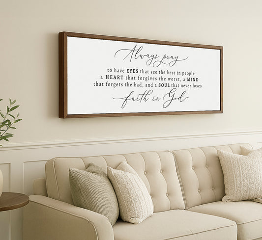 a living room with a couch and a framed quote on the wall