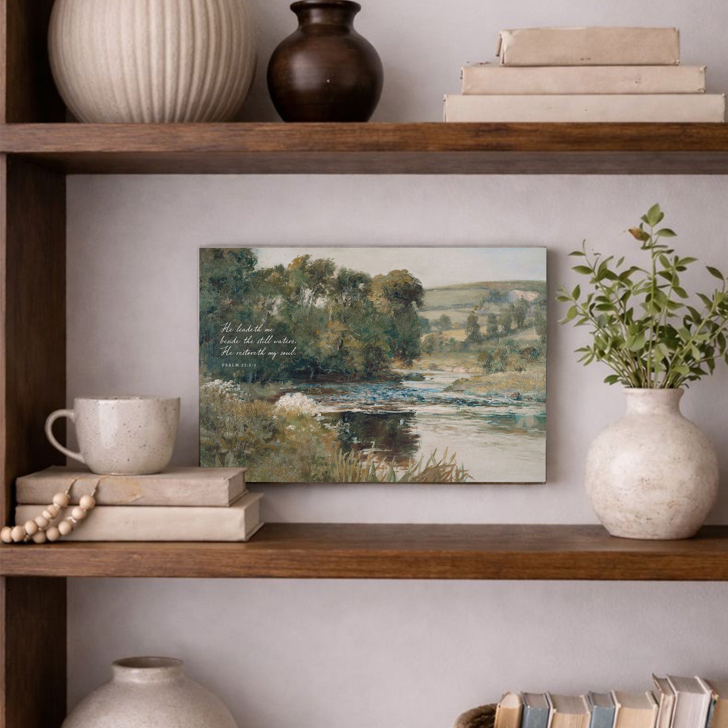 a wooden bookshelf with various decorative items and a framed landscape painting hanging on the wall.