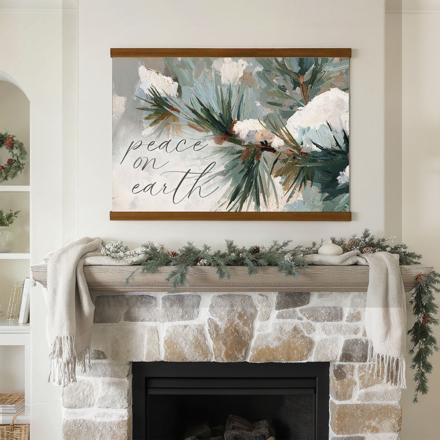 a fireplace mantel decorated with a wreath, pine branches, and a blanket. Above the mantel is a framed print with the text "Peace on earth" written on it.