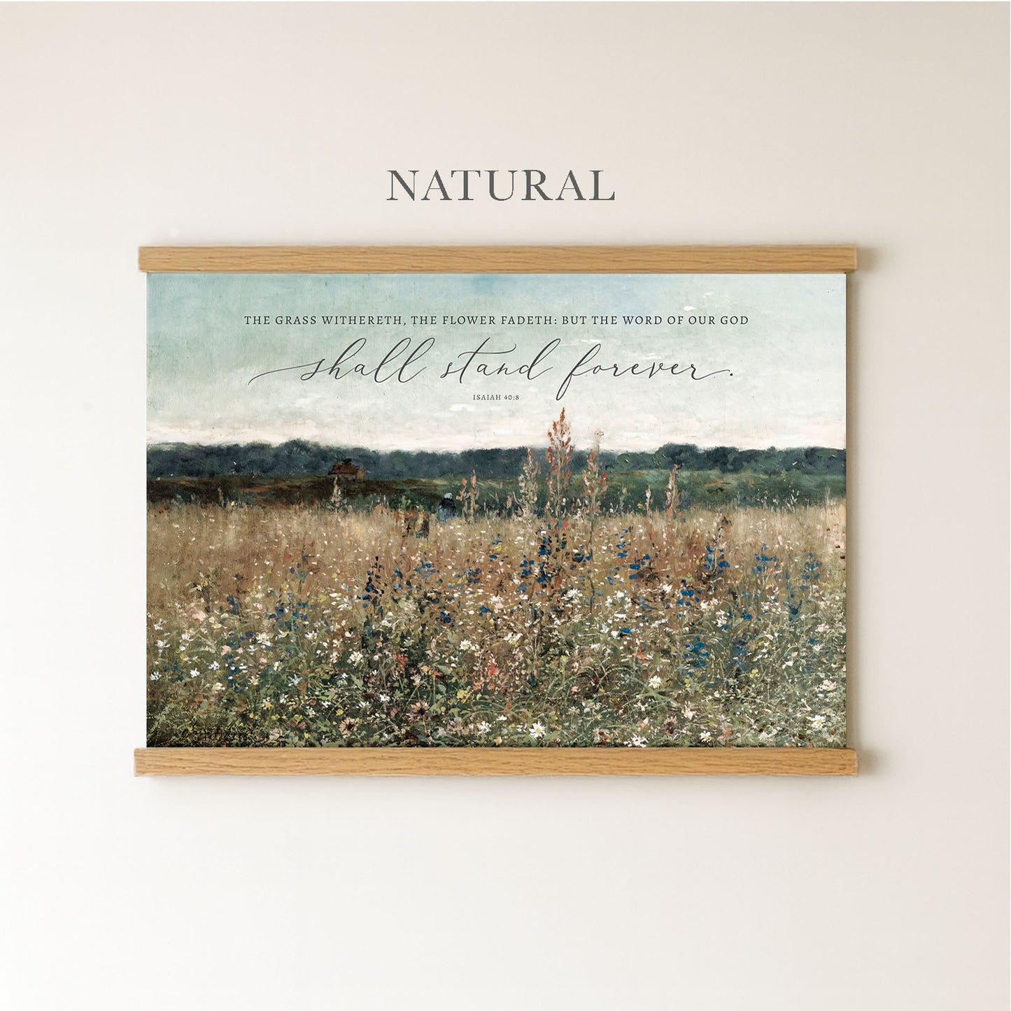 The image is a framed print of a pastoral landscape with a quote from the Bible, "The grass withstands the flower but the word of our God shall stand forever".