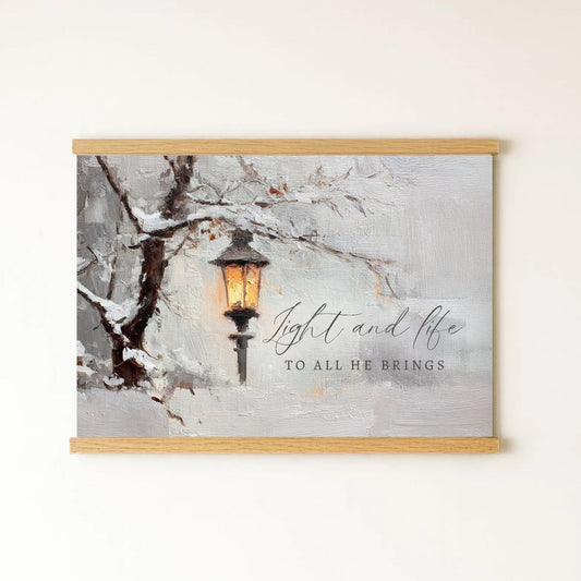 a lantern hanging from a tree branch, with snow-covered branches and a warm glow from the lantern.