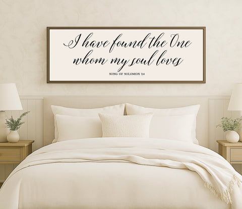 a bed with a white comforter and pillows