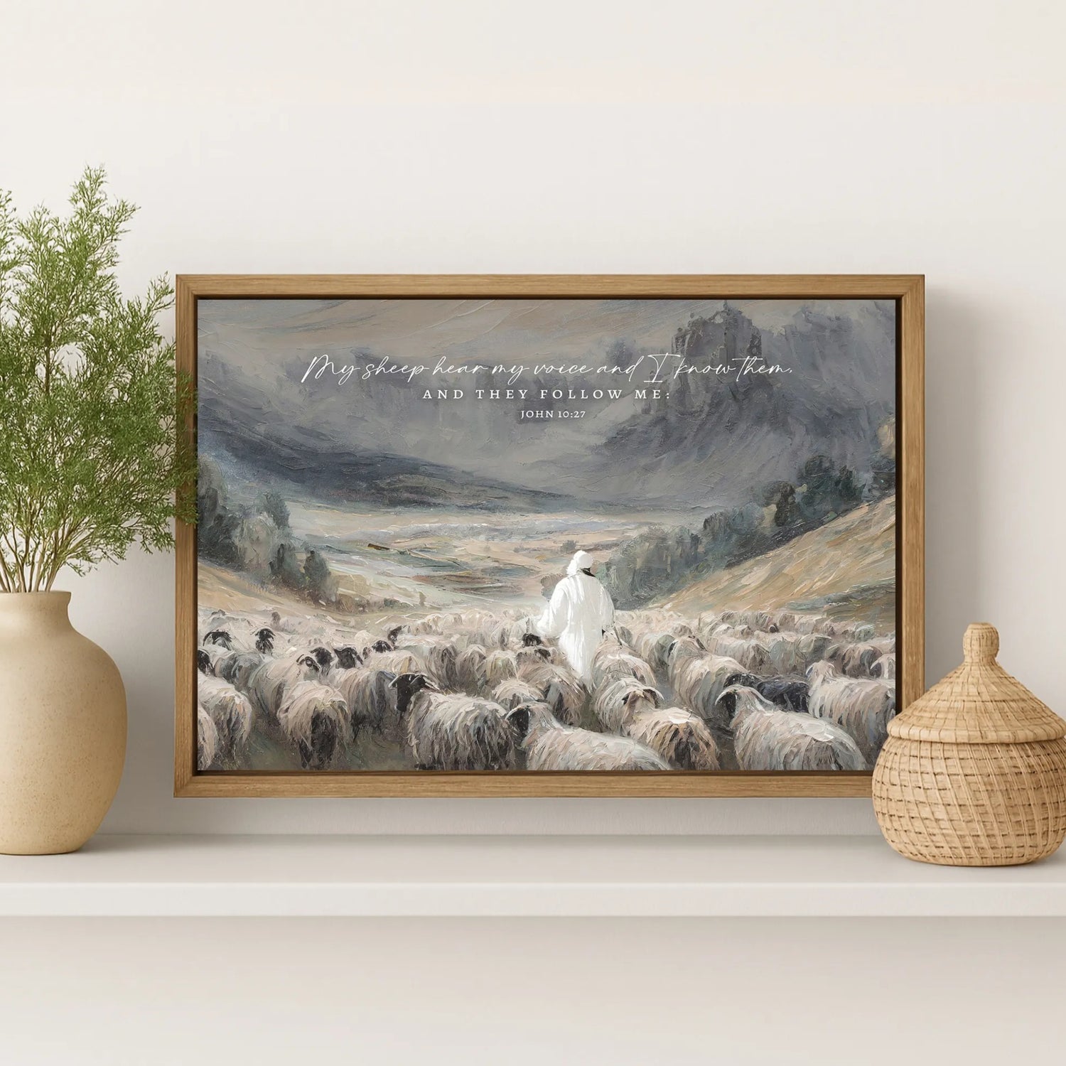 The image is a framed painting depicting a shepherd tending to his flock of sheep in a mountainous landscape.