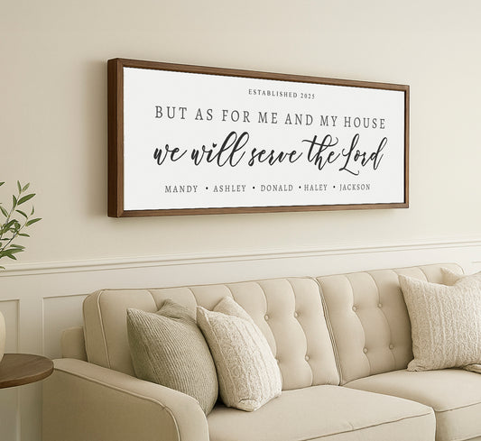 a living room with a couch and a framed sign on the wall