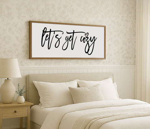 a bedroom with a bed, nightstand, and a picture on the wall