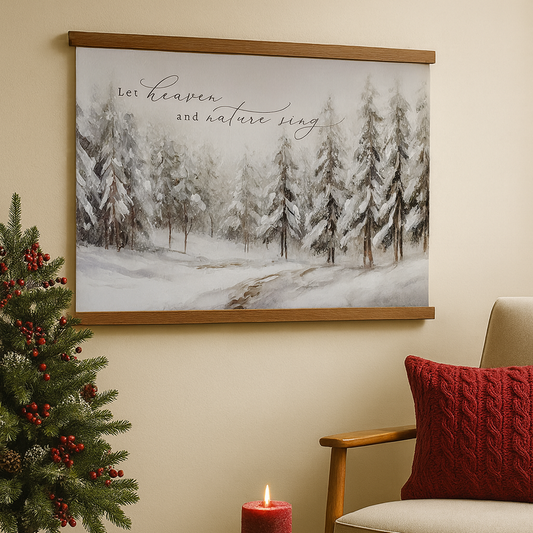 a cozy living room with a Christmas tree, a red pillow, and a candle on a table. Above the table, there is a framed painting of a snowy forest scene with the text "Let heaven and nature sing" written on it.
