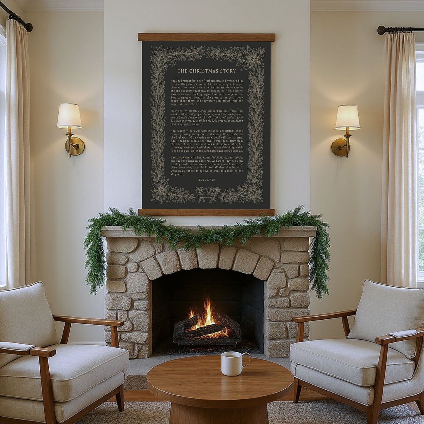 a cozy living room with a stone fireplace, a wooden coffee table, and two beige armchairs arranged around the fireplace. Above the fireplace hangs a black framed poster with a white border and gold lettering, which appears to be a quote or a story. The room is decorated with greenery and a garland, creating a warm and inviting atmosphere.