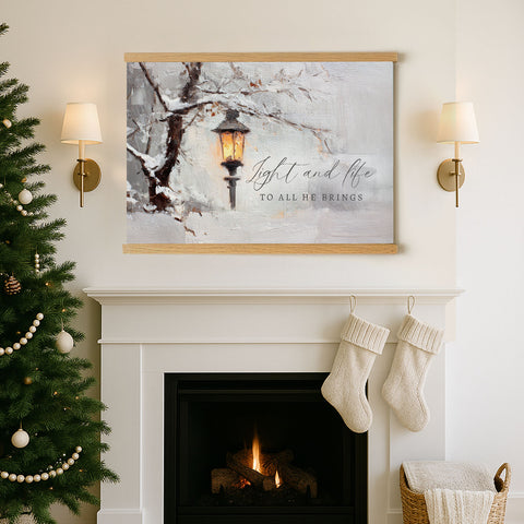 a cozy fireplace with a Christmas tree to the left and a framed painting of a street lamp above it. The painting has a winter scene with a street lamp and a snowy tree. The painting also includes the text 