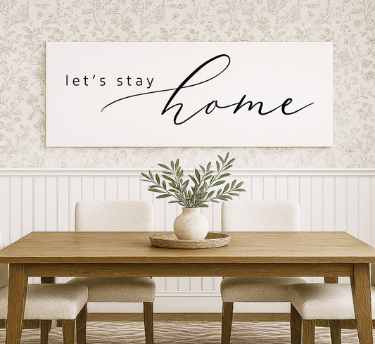 a dining room table with a plant in a vase