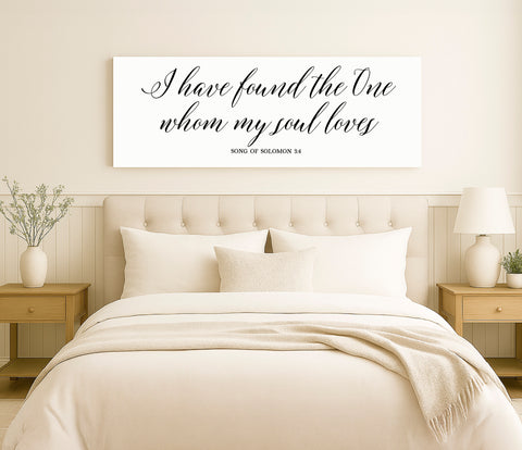 a bed with a white comforter and pillows