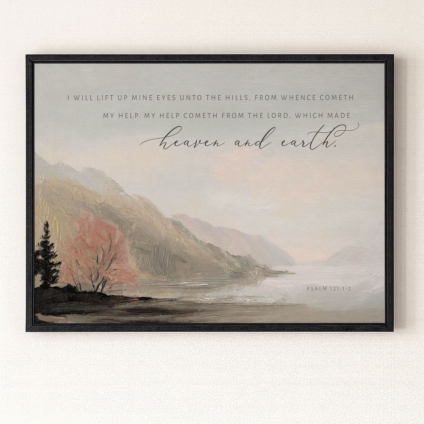 The image is a framed print featuring a serene landscape with mountains, trees, and a body of water. The text overlay provides a biblical verse from the book of Psalm 121:2, which reads "I will lift up mine eyes unto the hills, from whence comeeth my help, my help cometh from the LORD, which made heaven and earth."