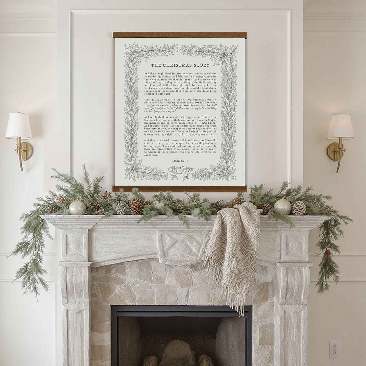 a fireplace mantel decorated with greenery, pine cones, and ornaments, with a framed text titled "The Christmas Story" displayed above it.