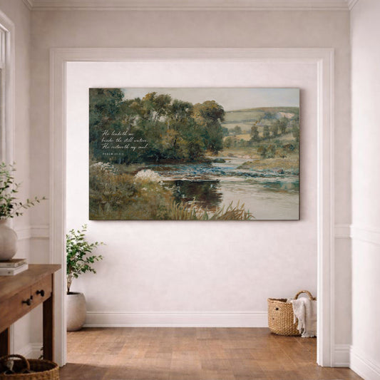 a large painting of a serene landscape with a river, trees, and a sky background, hanging on a white wall in a room with a wooden floor.