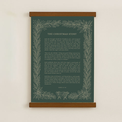 The image is a framed poster with a Christmas-themed design, featuring a central text box with a green background and a decorative border of leaves and flowers.
