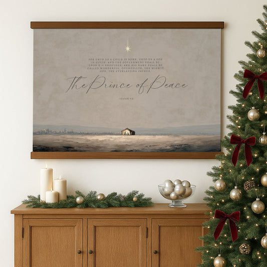 a wooden cabinet with a Christmas tree, candles, and ornaments, as well as a framed painting of a snowy landscape with a small house in the distance.