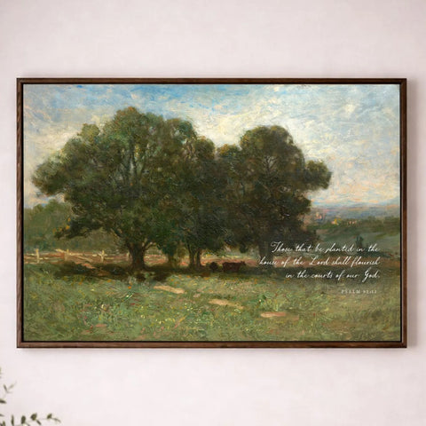 a painting of a serene landscape with a group of trees in the foreground and a peaceful countryside in the background. The painting is hung on a white wall above a wooden table with a vase of flowers on it.