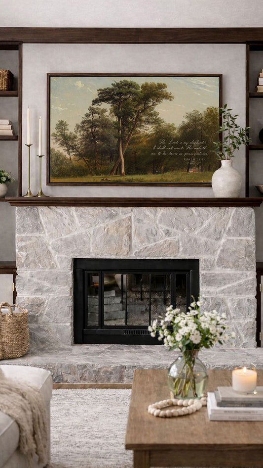 a cozy living room with a stone fireplace, a painting of a forest scene above it, and a wooden coffee table with a vase of white flowers.