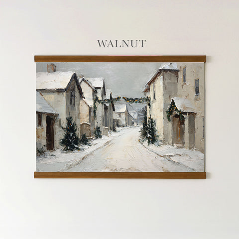 The image is a painting of a snowy village street, featuring houses, trees, and a path covered in snow.
