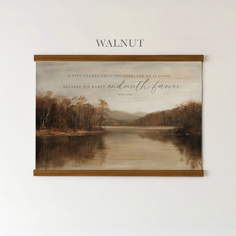 The image is a framed painting of a serene landscape with a lake and trees, hanging on a wall.