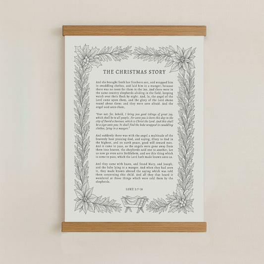 The image is a framed print of a Christmas story, featuring a decorative border with a floral design.