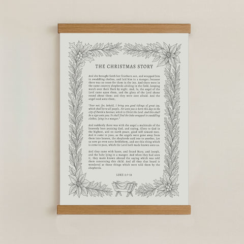 The image is a framed print of a Christmas story, featuring a decorative border with a floral design.