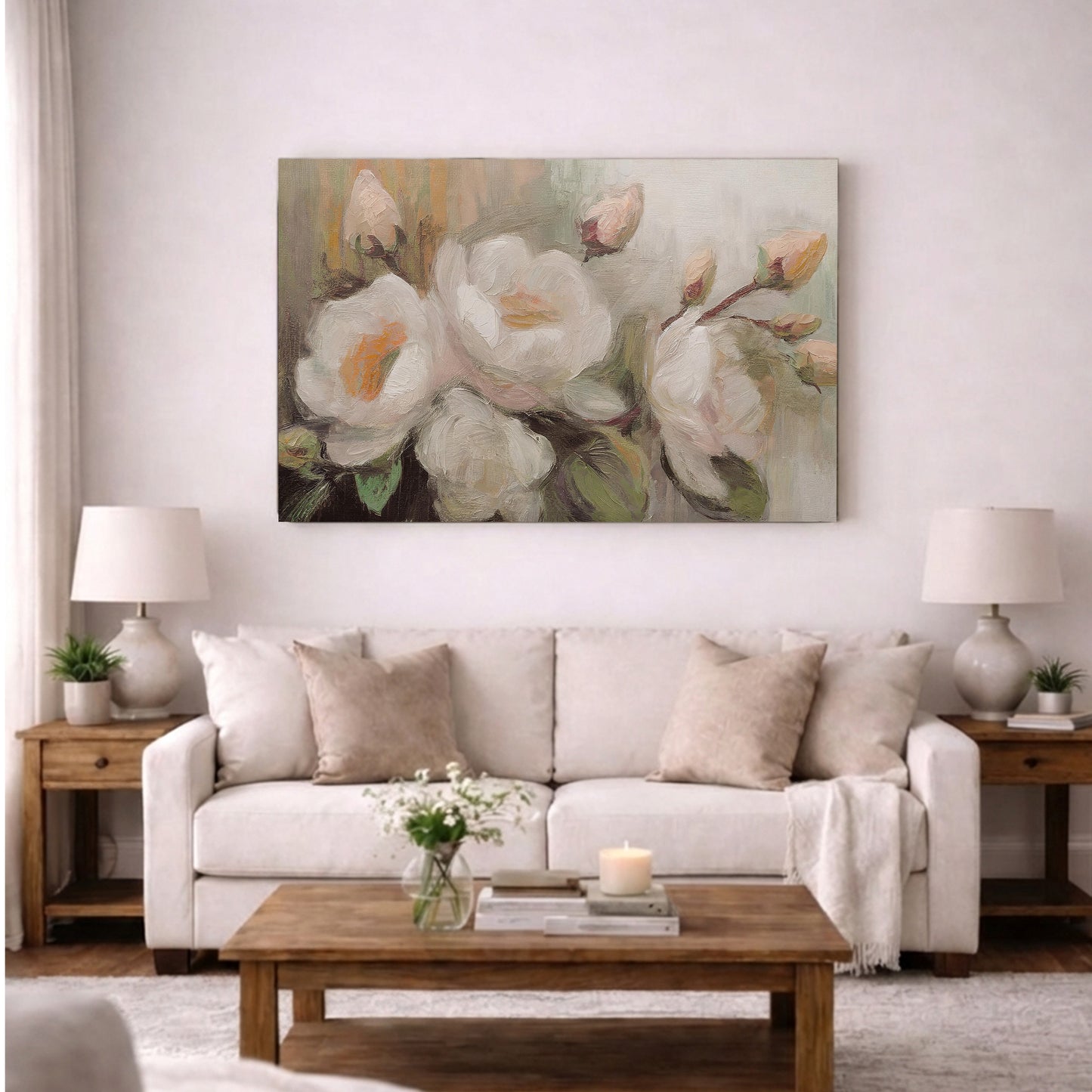 a cozy living room with a large floral painting hanging on the wall above a white sofa. The sofa is adorned with throw pillows and a vase of flowers. The room also features a wooden coffee table, two lamps, and a bookshelf, creating a warm and inviting atmosphere.