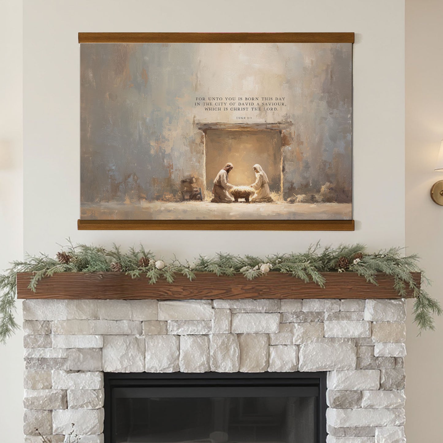 a painting of the Nativity scene, with two figures in a manger, surrounded by greenery and pine cones, mounted above a fireplace with a wreath on the mantel.