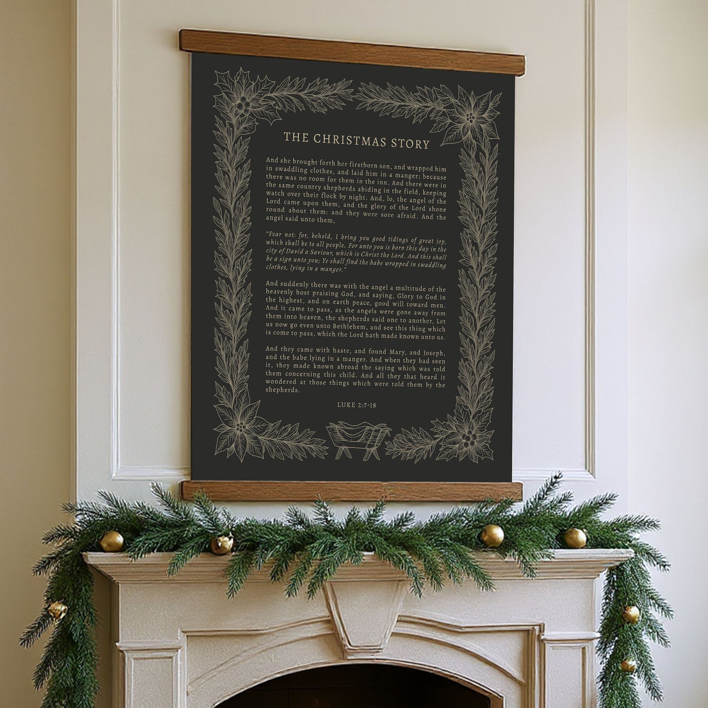 a fireplace decorated with a garland of pine branches and gold ornaments, with a black poster or banner hanging above it displaying the text "THE CHRISTMAS STORY" in a decorative font.