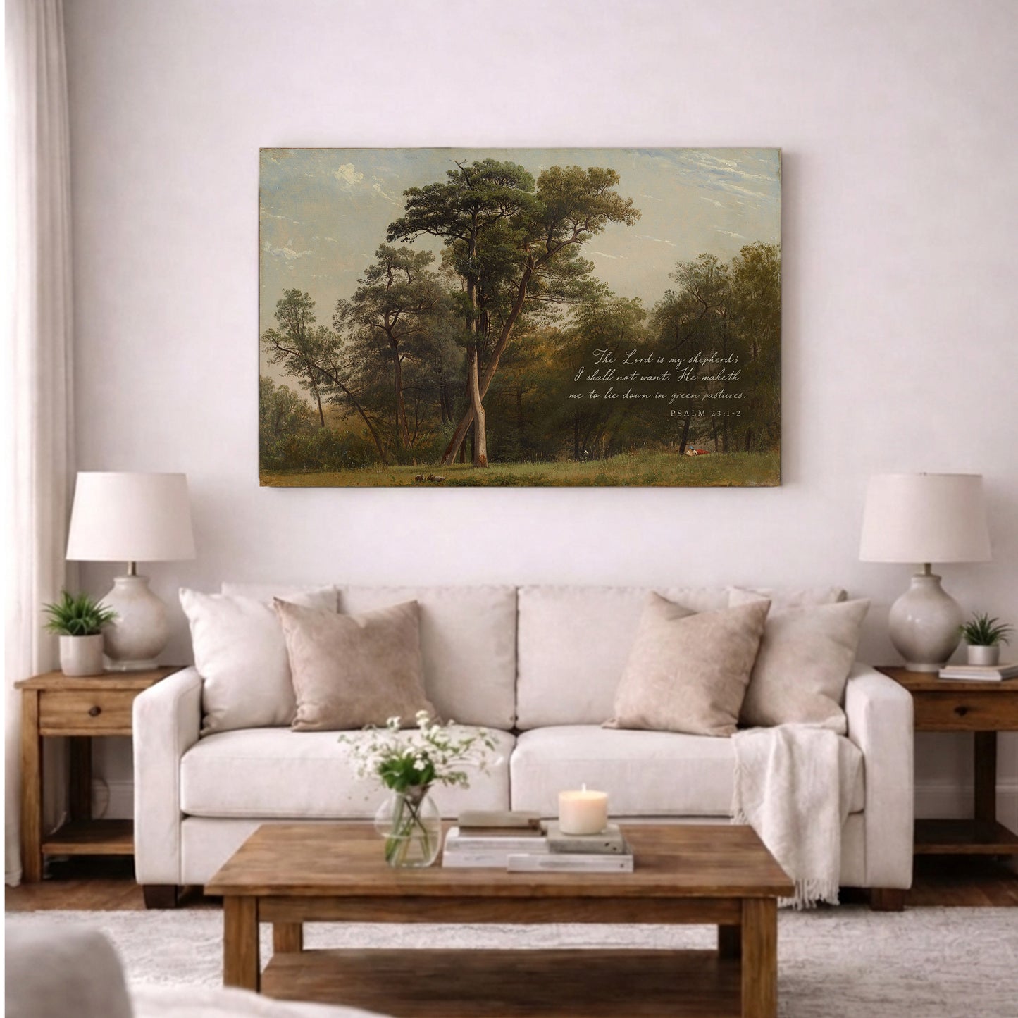 a living room with a large painting of a forest scene hanging on the wall above a white sofa. The sofa is adorned with throw pillows and a vase of flowers. In front of the sofa, there is a wooden coffee table with a book and a candle on it. The room also includes a lamp on a side table and a plant on a windowsill.
