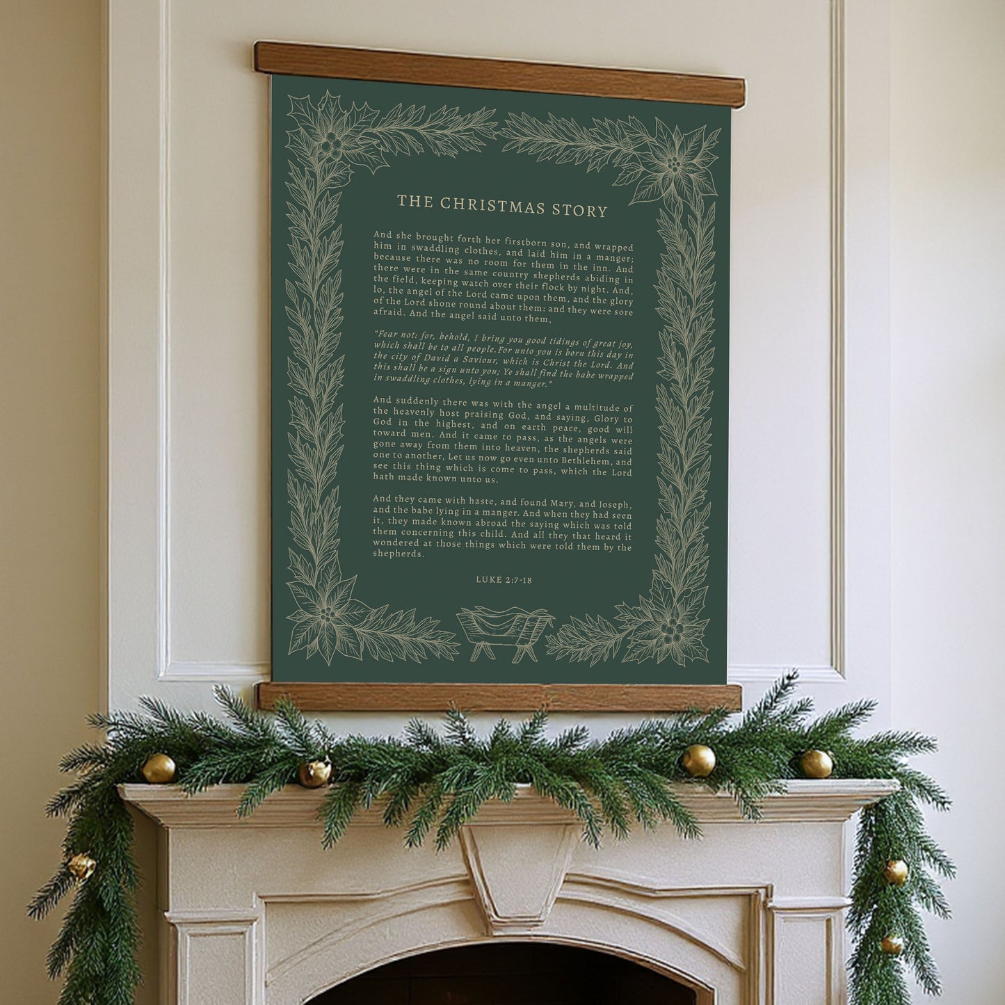 a fireplace mantel decorated with a garland of pine branches and gold ornaments, with a framed poster of a Christmas story hanging above it.