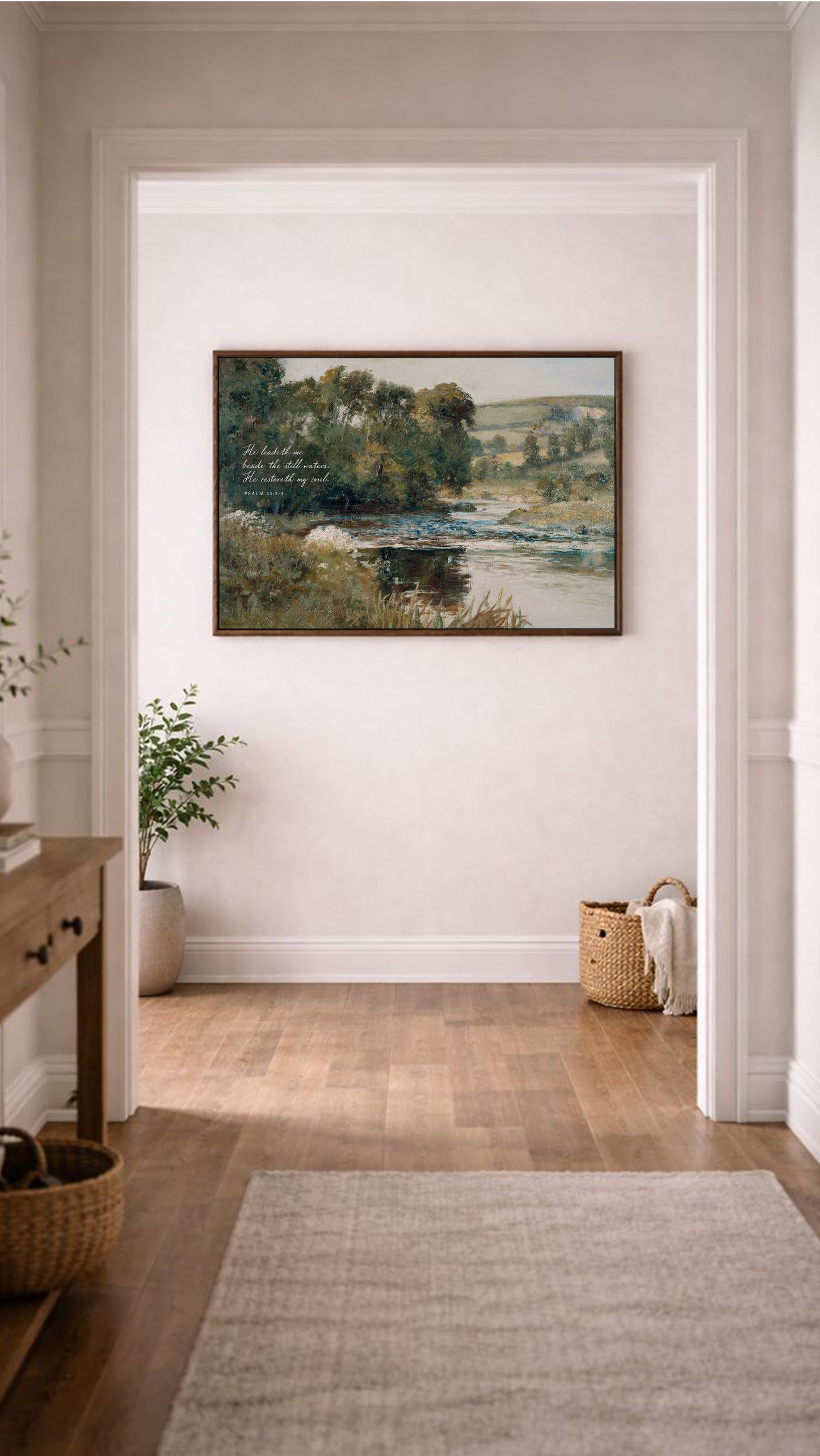 a large painting of a serene landscape hanging on a white wall in a hallway. The painting depicts a peaceful scene with a river, trees, and a field, creating a calming atmosphere. The hallway has a wooden floor and a rug, adding to the overall aesthetic of the space.